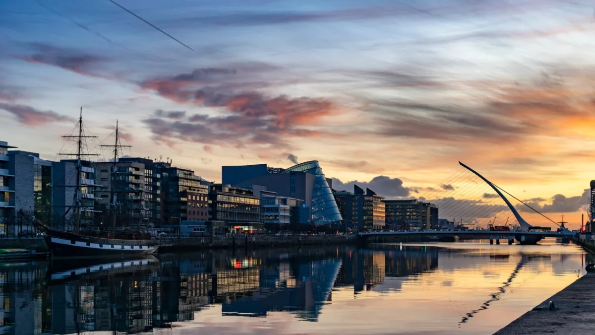 A port at sunset with an old-fashioned ship.