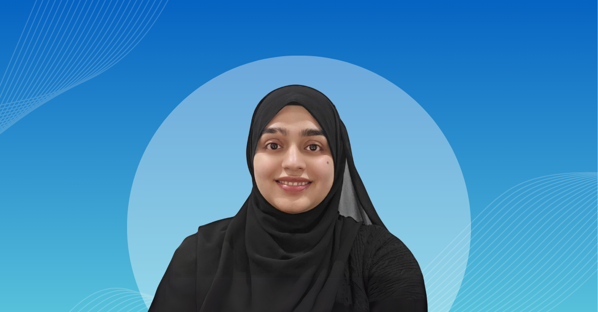 Faiza Qazi in front of a blue background.