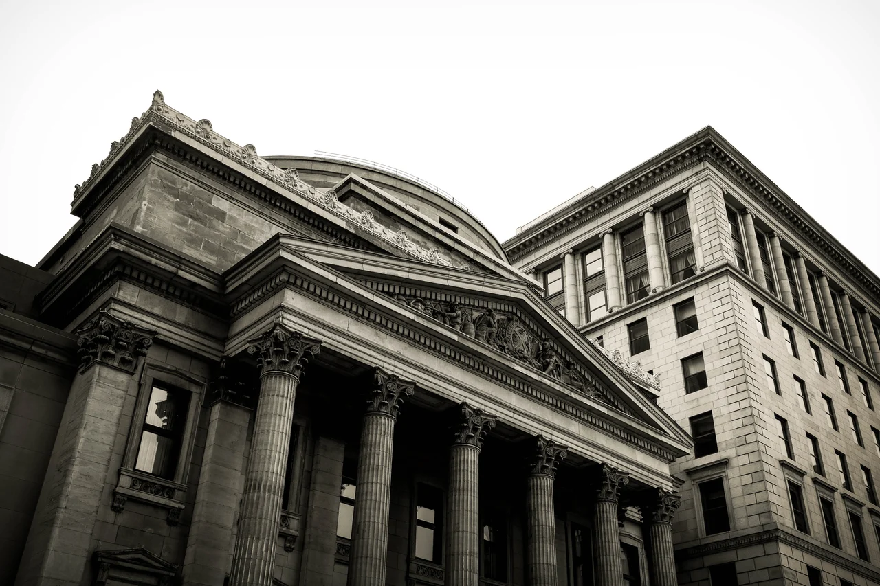 A large, ornate building with stone pillars in black and white.