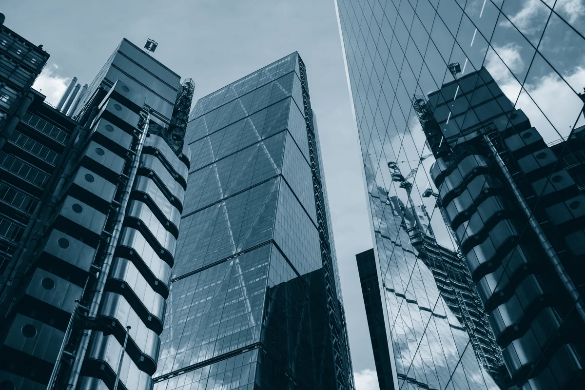 Duotone skyscrapers against a clear sky.