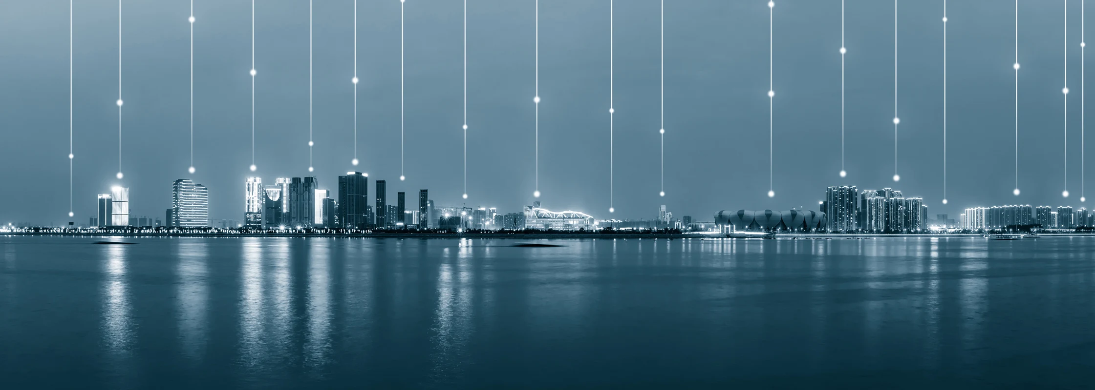 A cityscape with lights shooting into the sky.