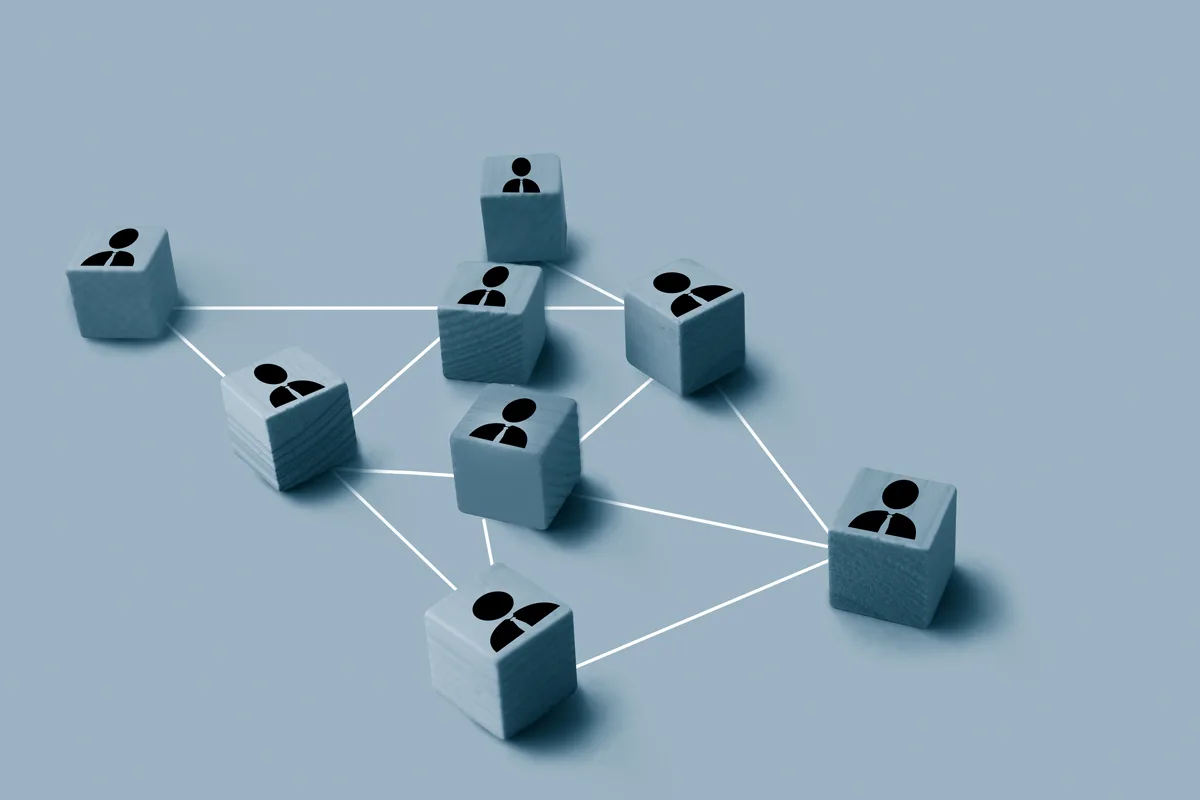 Blocks with peoples' silhouettes on them connected with white lines.