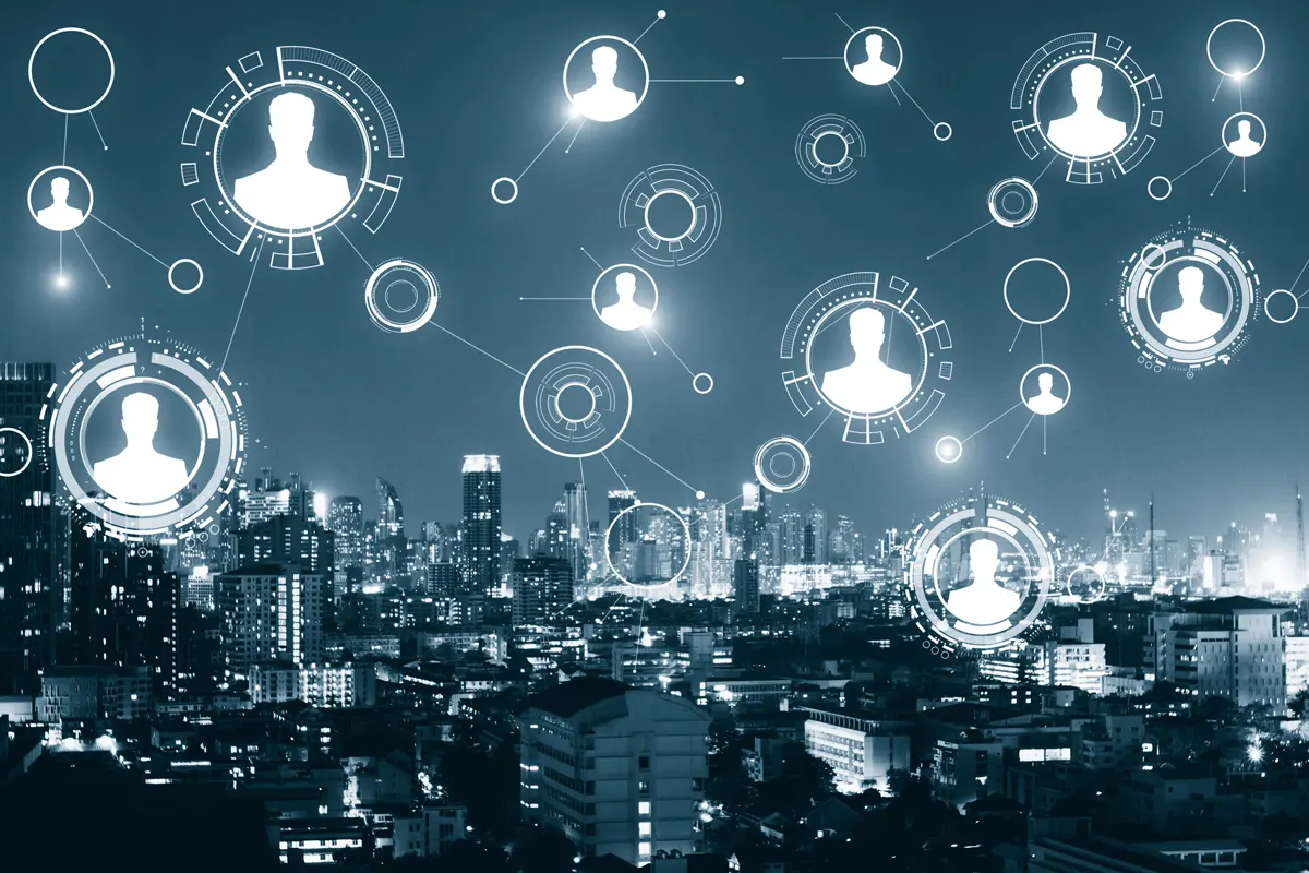 Icons of people above a cityscape.