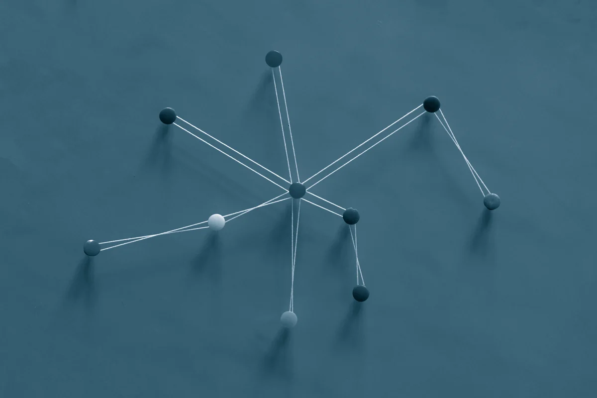 Pins in a board connected with string.